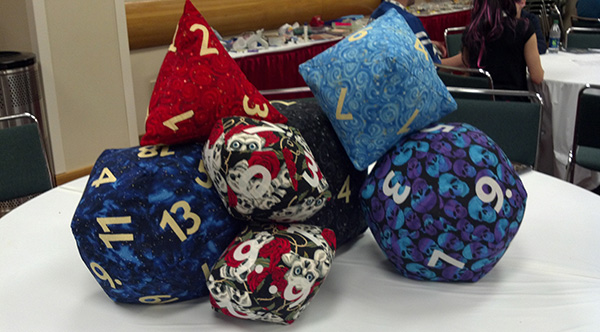 All the dice pillows, piled on a table.
