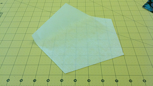 A pentagon-cut piece of interfacing, slightly smaller than the pentagon-cut piece of fabric.